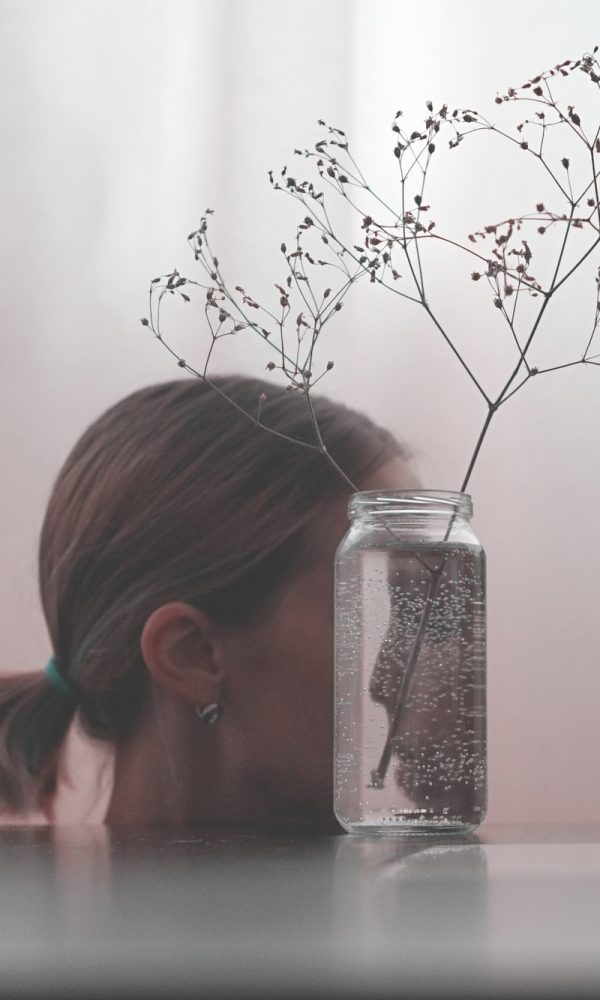 The girl's face reflected in a glass jar. Look into yourself. The psychological concept.